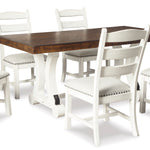 A 7-piece dining room set featuring a rectangular table with a dark brown wood top and white trestle base, surrounded by six white ladder-back chairs with off-white upholstered seats and silver nailhead trim.
