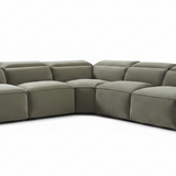 Modern living room with a sectional sofa, coffee table, and decorative elements.