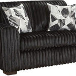 A black corduroy loveseat sofa with two black and white patterned accent pillows, shown against a plain white background.