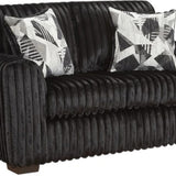 A black corduroy loveseat sofa with two black and white patterned accent pillows, shown against a plain white background.
