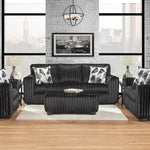 Black sofa set in a modern living room with large windows and a cityscape view.