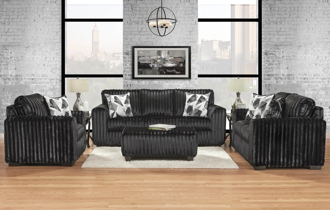 Black sofa set in a modern living room with large windows and a cityscape view.