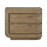 A rustic two-drawer nightstand with a curved front and a weathered, light brown wood finish, shown against a plain white background.