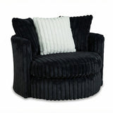 A modern barrel-style accent chair upholstered in a dark charcoal gray corduroy fabric, featuring a white ribbed throw pillow, set against a plain white background.