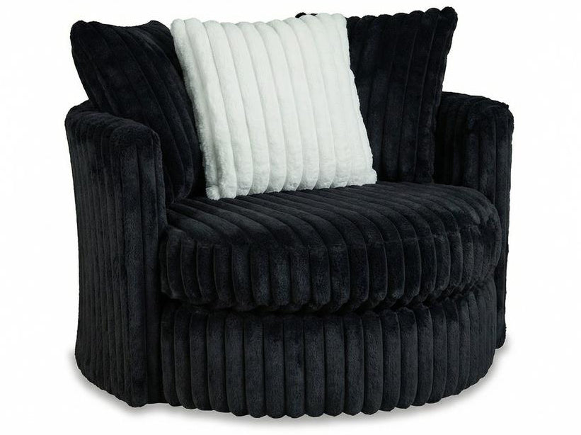 A modern barrel-style accent chair upholstered in a dark charcoal gray corduroy fabric, featuring a white ribbed throw pillow, set against a plain white background.