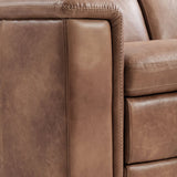 Close-up of a brown leather reclining sofa showing the armrest, seat cushion, and decorative stitching.