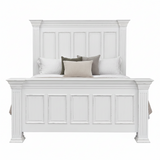 A white wooden bed frame with a tall paneled headboard and matching footboard, styled with white, gray, and beige pillows on a plain white background.