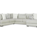 Gray sectional sofa with patterned cushions on a white background
