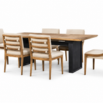 A 7-piece dining room set featuring a rectangular wooden table with a black metal pedestal base and six matching chairs with beige upholstered seats and backs, shown on a solid white background.