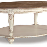 Ashley Furniture - REALYN OVAL COCKTAIL TABLE - Light Brown Wood - Tables