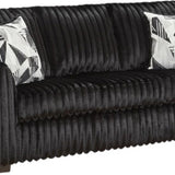 A black ribbed sofa with two black and white patterned accent pillows, shown against a plain white background.