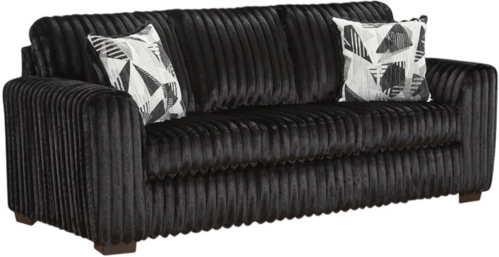 A black ribbed sofa with two black and white patterned accent pillows, shown against a plain white background.