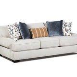 A light beige upholstered loveseat sofa with dark wooden feet, styled with five decorative throw pillows including two navy blue velvet pillows, a tan and white striped pillow, and two white floral patterned pillows, shown against a plain white background.