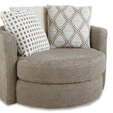 A round upholstered accent chair in textured taupe fabric, featuring two decorative throw pillows with geometric patterns, set against a plain white background.