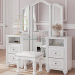 White vanity table set with a three-panel mirror, glass shelf, drawers, and a matching white stool in a softly styled bedroom interior.