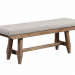 A rustic wooden bench with a light gray upholstered seat cushion, shown on a plain white background.