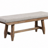 A rustic wooden bench with a light gray upholstered seat cushion, shown on a plain white background.
