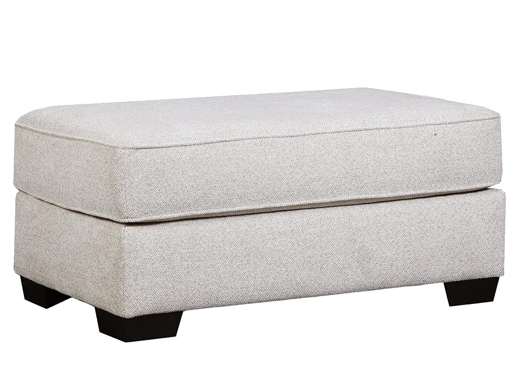 A rectangular upholstered ottoman with a textured light beige fabric and dark block feet, shown on a plain white background.