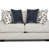 A light beige upholstered loveseat with two dark navy velvet throw pillows and two patterned accent pillows, shown against a plain white background.