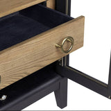 Close-up of a black wooden cabinet with an open door and a partially pulled-out drawer, showing light oak wood interior, a dark velvet lining, and brass ring pulls on a white background.