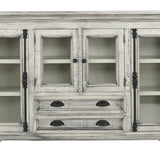 A distressed white wood accent cabinet with glass-front upper doors, open shelves, and two lower drawers with dark metal pulls, shown on a plain white background.