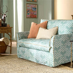 Patterned sofa with decorative pillows in a living room setting