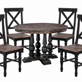 A 5-piece rustic dining set featuring a round dark wood table with turned pedestal legs and four matching black chairs with X-backs and distressed brown wooden seats, shown on a white background.