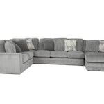 A light gray fabric sectional sofa with a left-facing chaise lounge and multiple decorative throw pillows, shown against a plain white background.