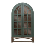 An arched glass-front cabinet with a muted sage green frame and dark brown wood interior and base, shown against a plain white background.