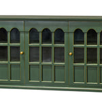 A green wooden sideboard cabinet with three glass-paneled doors and small gold knobs, shown against a plain white background.