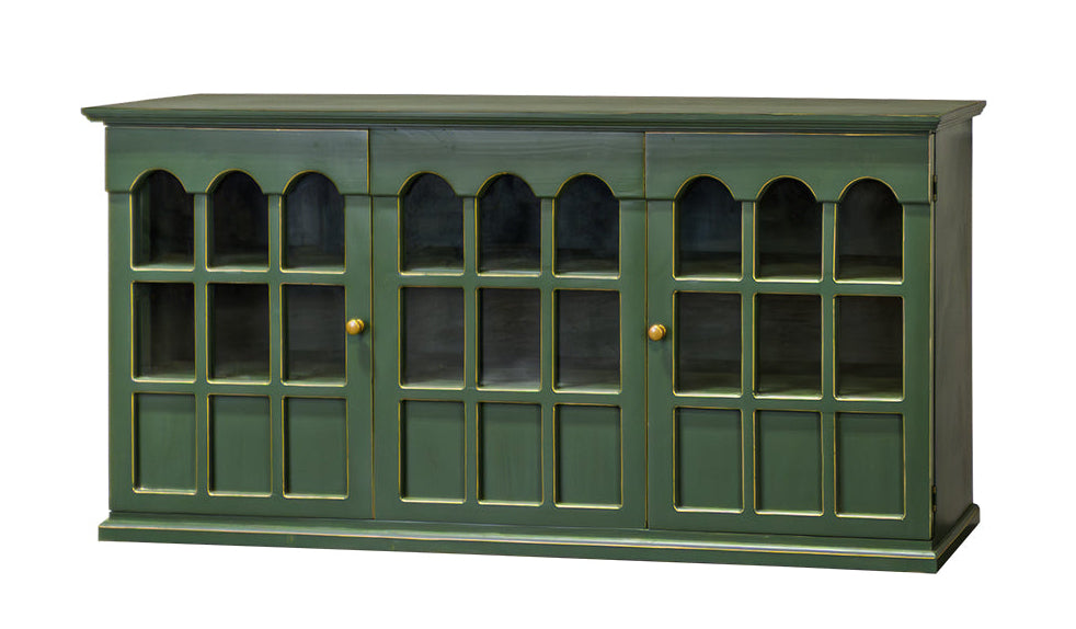 A green wooden sideboard cabinet with three glass-paneled doors and small gold knobs, shown against a plain white background.