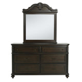 A dark brown wooden dresser with six drawers and an attached rectangular mirror featuring an ornate carved top frame, shown against a plain white background.