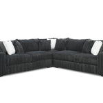 Black sectional sofa with white cushions on a white background