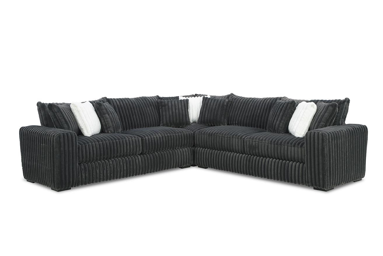 Black sectional sofa with white cushions on a white background