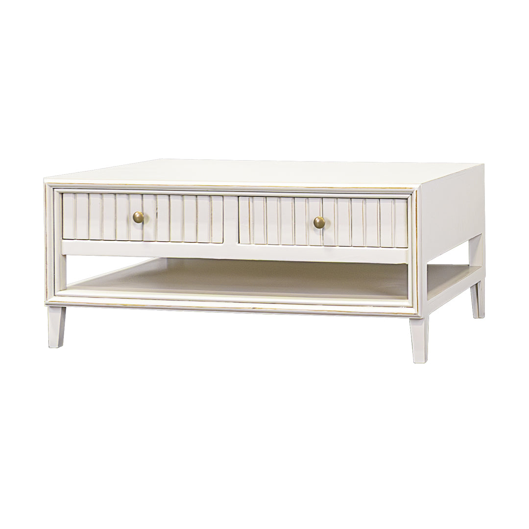 White coffee table with a single drawer and gold handles on a white background