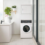 Modern laundry room with stacked washer and dryer, plant, and basket.