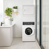 Modern laundry room with stacked washer and dryer, plant, and basket.